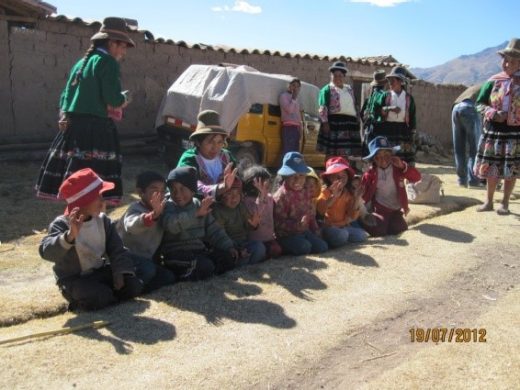 Peruanische Kinder winken den Besuchern zu